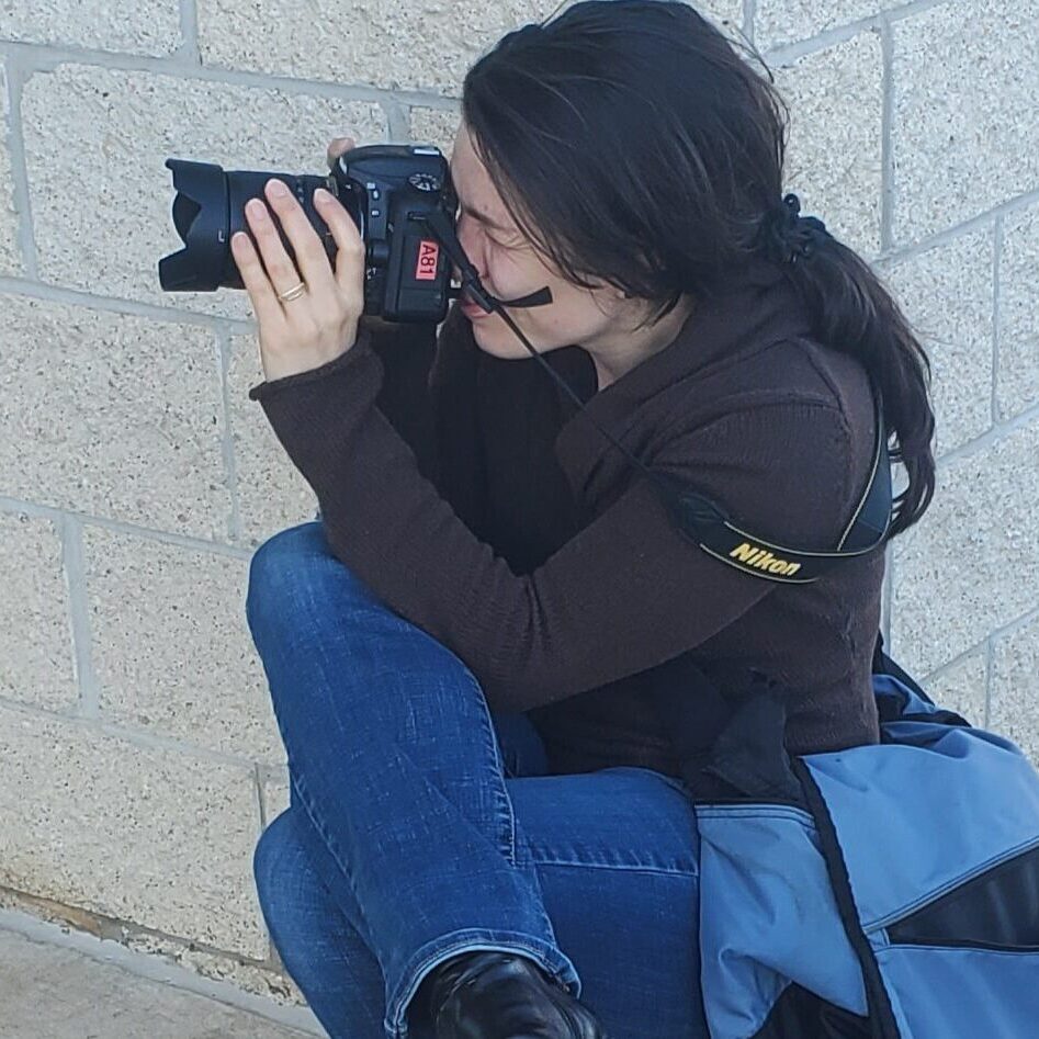 Alisha is taking a photo outside of Ross in Laurel Maryland as part of a photography series for a news story.