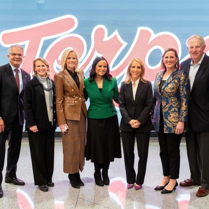 Sunday Show panelists stand in front of Terps banner for photo.