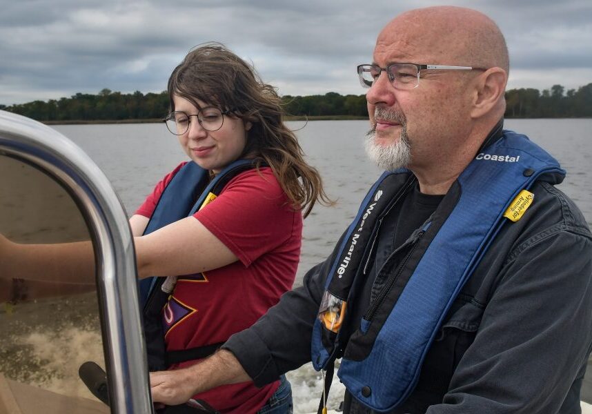 JOPPA, Md. - Theaux Le Gardeur (right), executive director of the Gunpowder Riverkeeper, is joined by researcher Andrea Rudai (left) as they collect water samples on the Gunpowder River. (Alisha Camacho/Capital News Service)
